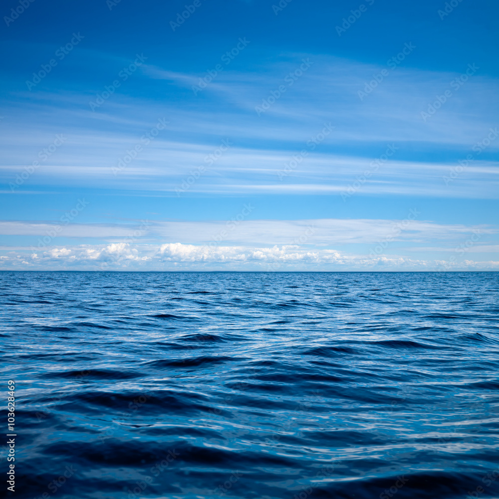 Obraz premium Blue sky with clouds over a rippled lake natural background