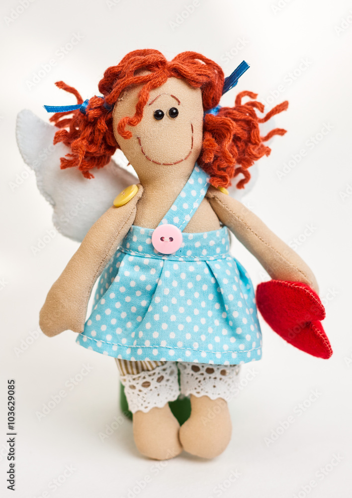 Fototapeta premium Doll angel with his hands on white background