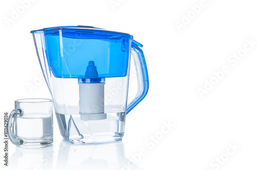 Water filter pitcher and glass on white background