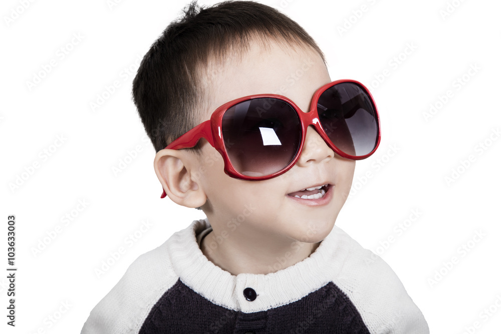 Smart cute kid is wearing sunglasses and smiling Smart cute kid is wearing sunglasses and smiling