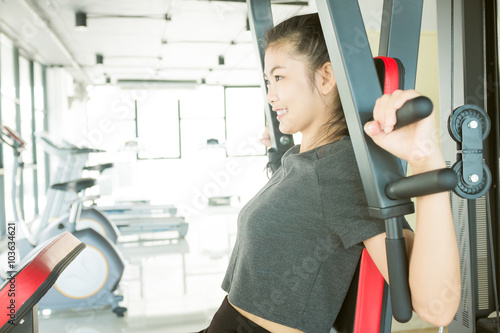 Sport woman exercising on machine