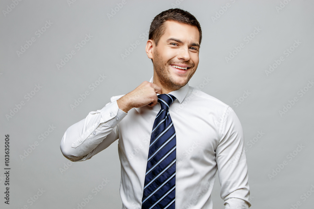 Handsome stylish businessman on grey background Handsome stylish businessman on grey background