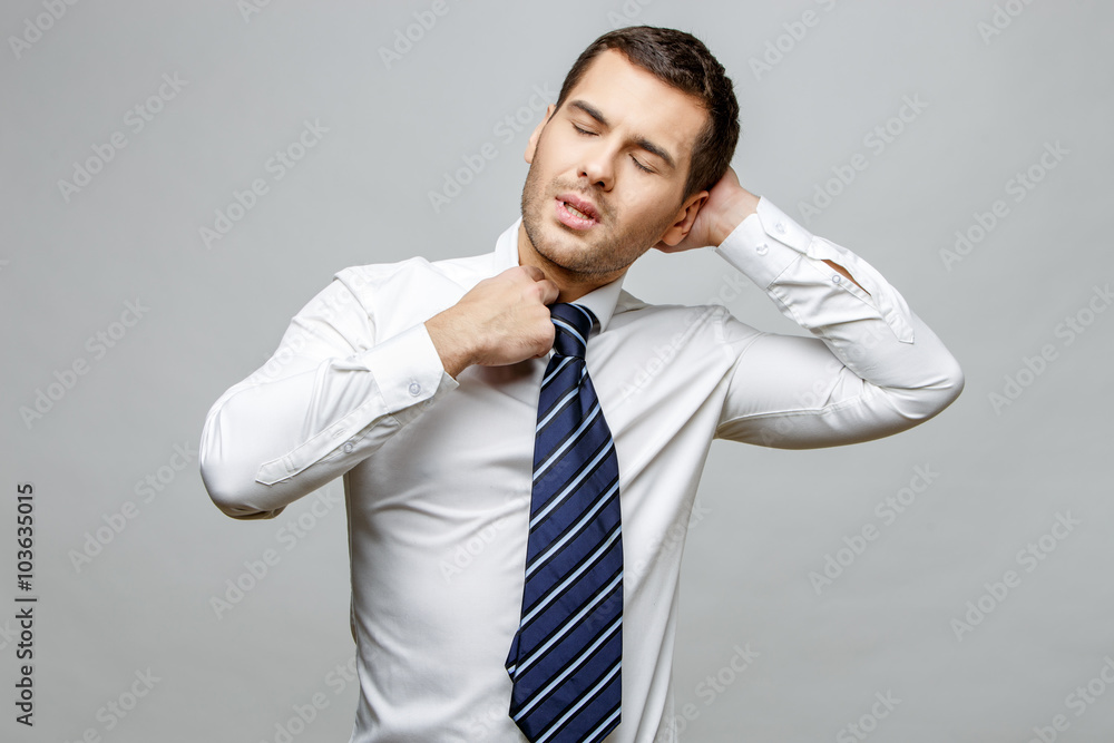 Handsome stylish businessman on grey background Handsome stylish businessman on grey background