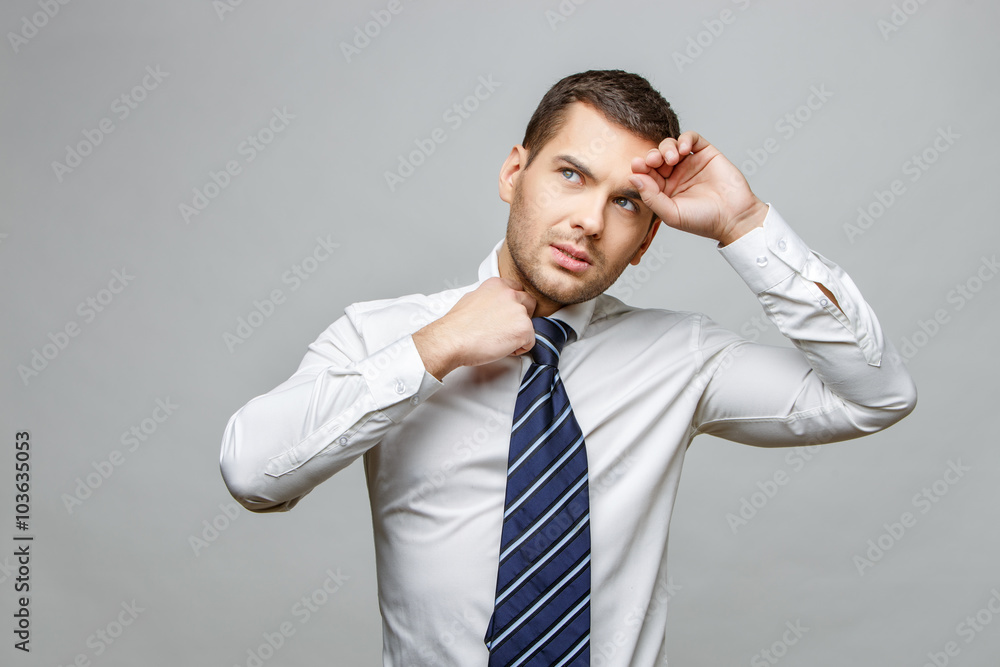Handsome stylish businessman on grey background Handsome stylish businessman on grey background