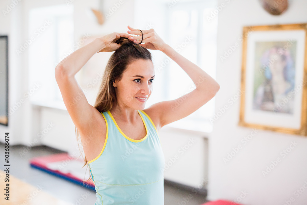 Fit Brunette Woman with Blue Sports Shirt and Black Leggings at Fit Brunette Woman with Blue Sports Shirt and Black Leggings at