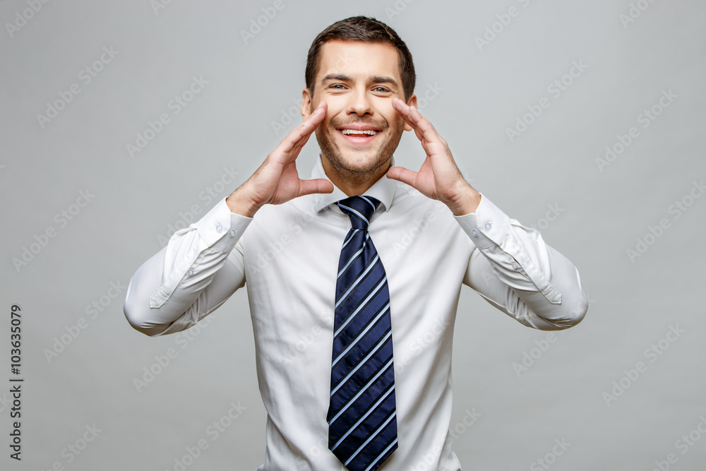 Handsome stylish businessman on grey background Handsome stylish businessman on grey background
