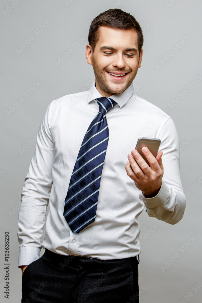 Handsome stylish businessman on grey background Handsome stylish businessman on grey background
