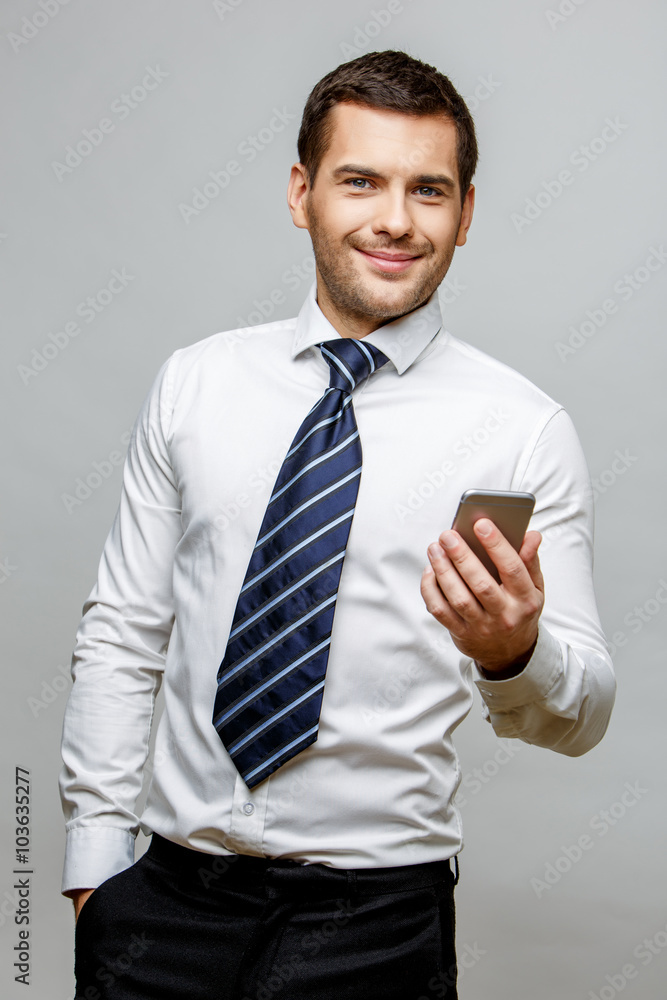 Handsome stylish businessman on grey background Handsome stylish businessman on grey background