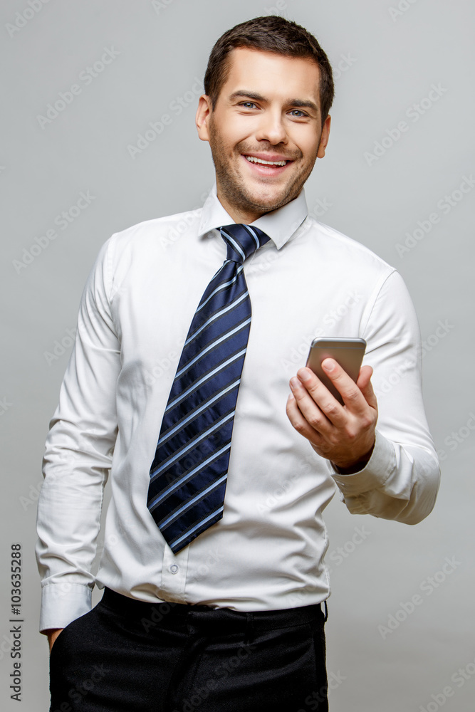 Handsome stylish businessman on grey background Handsome stylish businessman on grey background