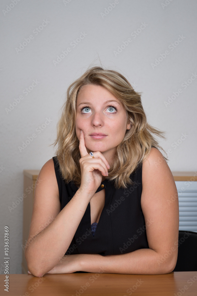 Thoughtful woman looking up - isolated over a white background Thoughtful woman looking up - isolated over a white background