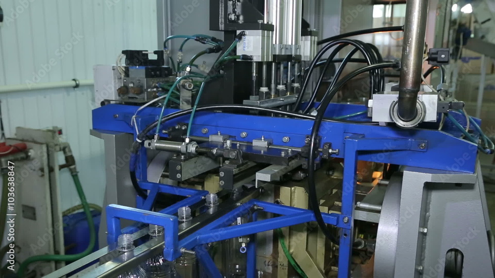 Production of plastic bottles.Automatic system. The production of plastic products. Conveyor. Machine to produce plastic bottles. Press.High production speed. The billet is heated then blown bottle. Production of plastic bottles.Automatic system. The production of plastic products. Conveyor. Machine to produce plastic bottles. Press.High production speed. The billet is heated then blown bottle.