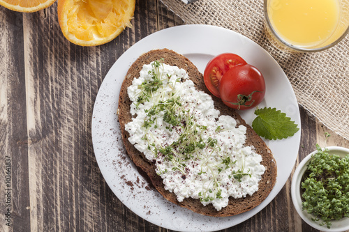healthy spring summer low fat breakfast with orange juice,coffee,bread,cottage cheese, cress and tomatos