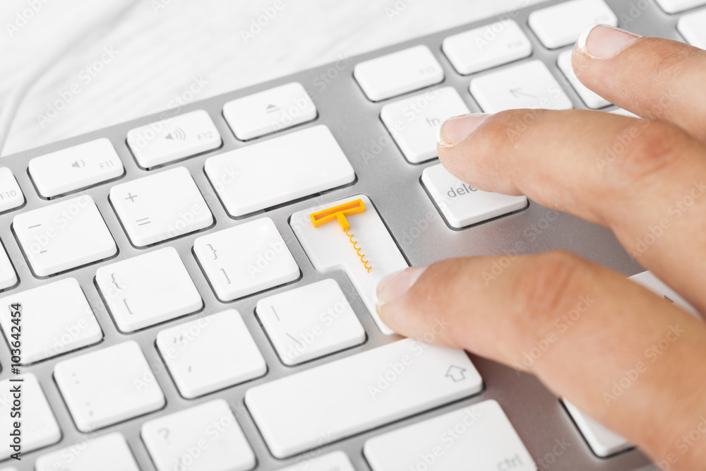 Woman pressing wine delivery button on computer keyboard Woman pressing wine delivery button on computer keyboard