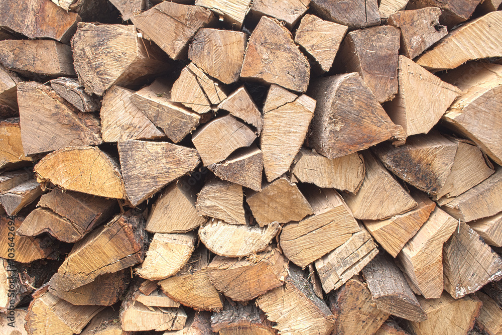 Background of chopped firewood stacked up on top of each other in a pile Background of chopped firewood stacked up on top of each other in a pile