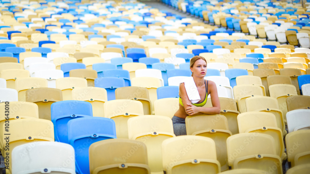 Fototapeta premium Young sportswoman is at large modern stadium