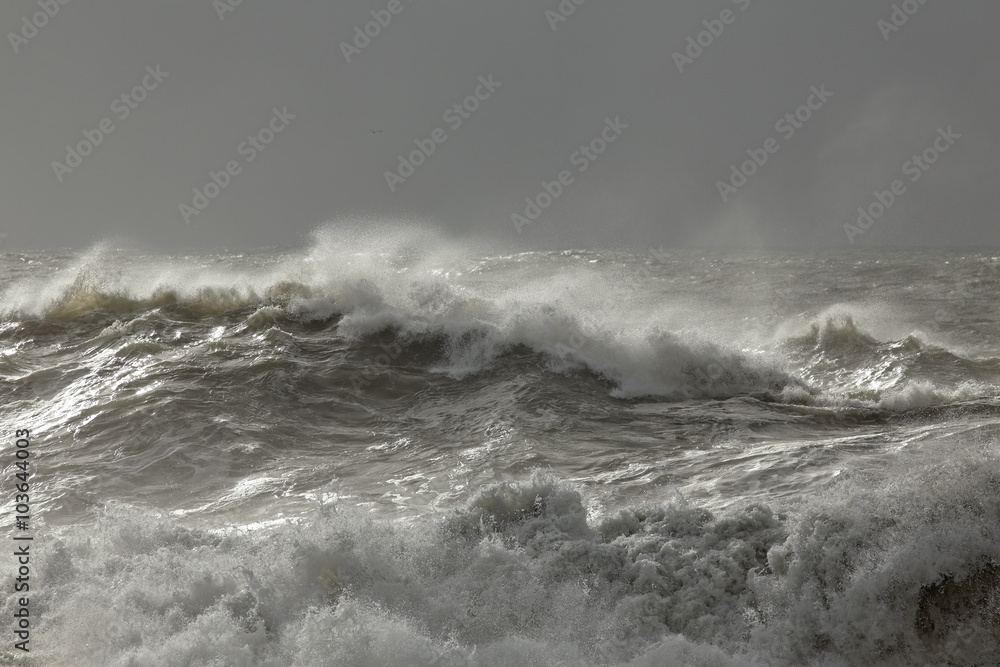 Stormy sea waves with winter light