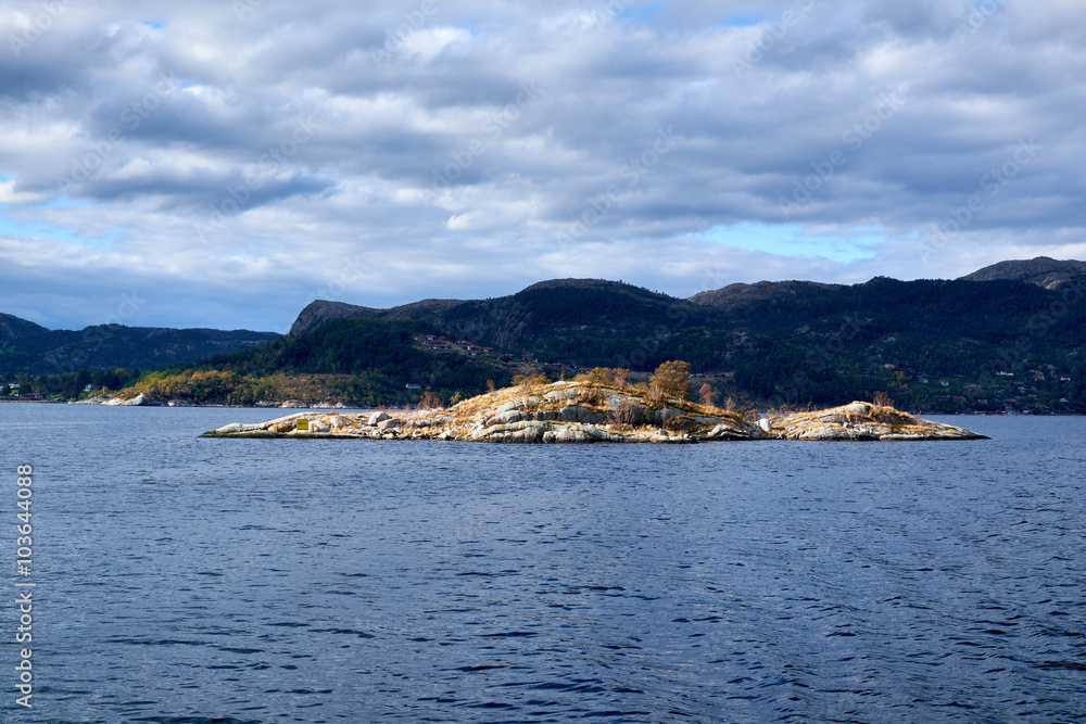 Very small rock island with single trees situated in Lysefjord Norway