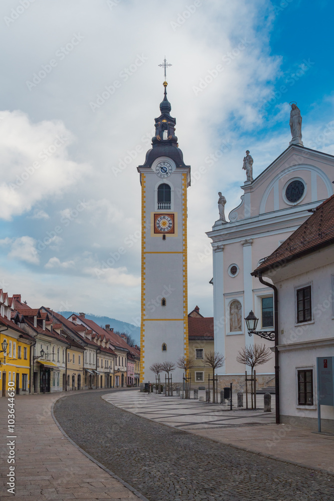 Obraz premium Kamnik, Slovenia - January 25, 2016. Church of the Immaculate Conception with its Tower on the main town street called Sutna.