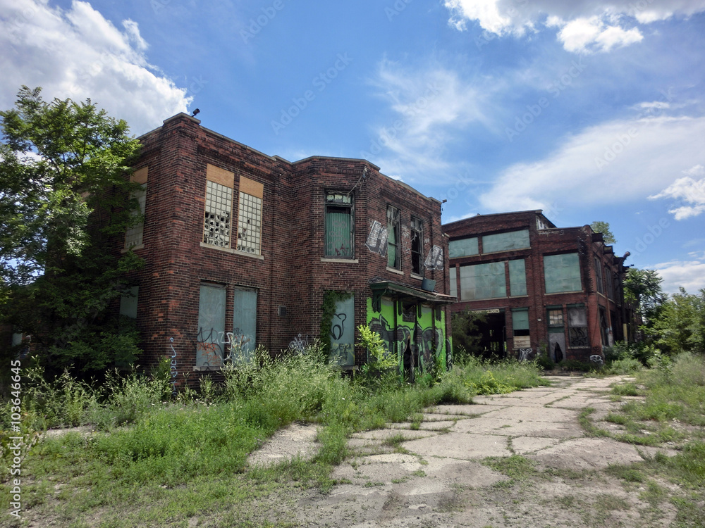 Abandoned old brick buildings with overgrown weeds and broken windows - landscape color photo Abandoned old brick buildings with overgrown weeds and broken windows - landscape color photo