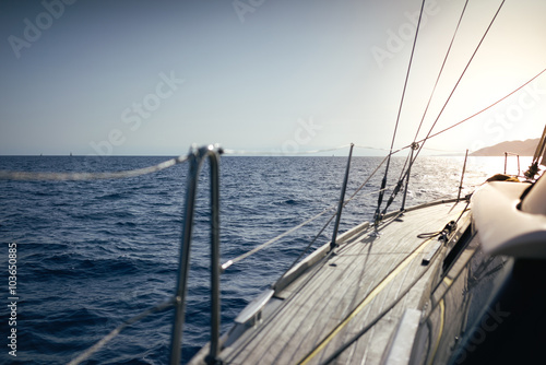 Sailing yacht boat on ocean water at sunset © JKstock