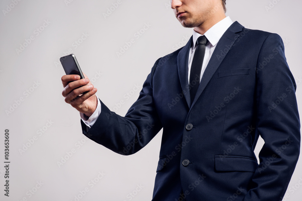Hipster businessman with smartphone writing text message. Studio Hipster businessman with smartphone writing text message. Studio