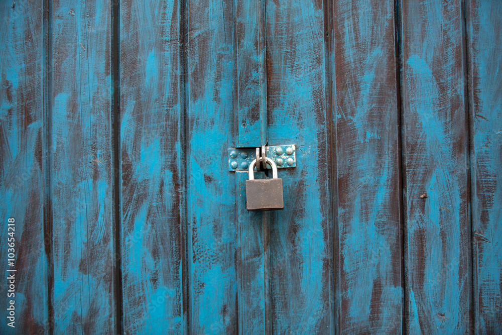 Close up of an antique wooden door painted in blue Close up of an antique wooden door painted in blue