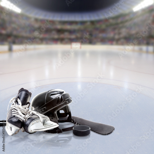 Dramatic Hockey Arena With Equipment on Reflective Ice and Copy Space. Deliberate focus on foreground equipment and shallow depth of field on background. Lighting flare effect.