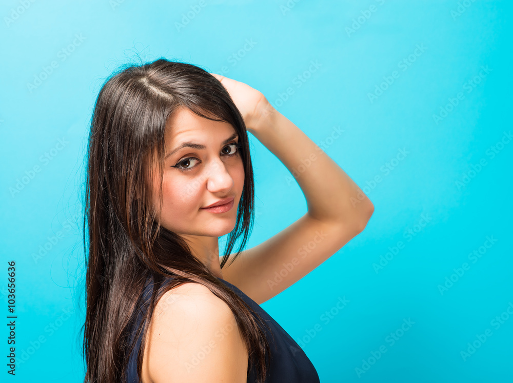woman holding hand on head blue background woman holding hand on head blue background