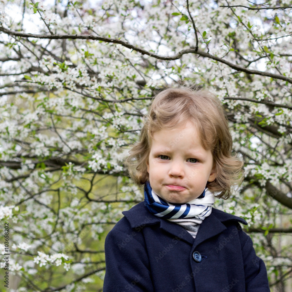 Spring time. Little funny girl (3 years) near flowering trees. Spring time. Little funny girl (3 years) near flowering trees.