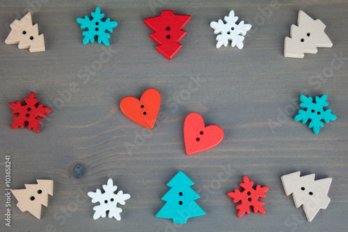 Red hearts, trees and snowflakes on grey wooden background. Button love. Wooden buttons. Post card for the Valentine. Valentine's Day postcard.