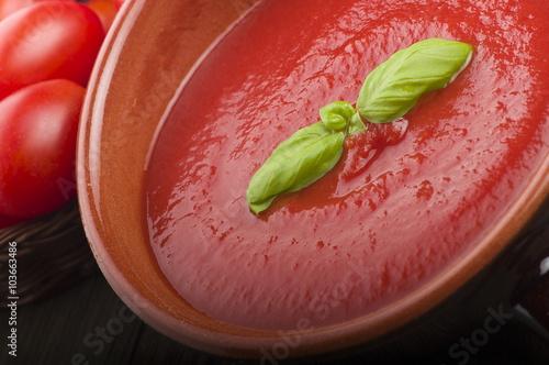  pot with tomato sauce and basil leaves photo