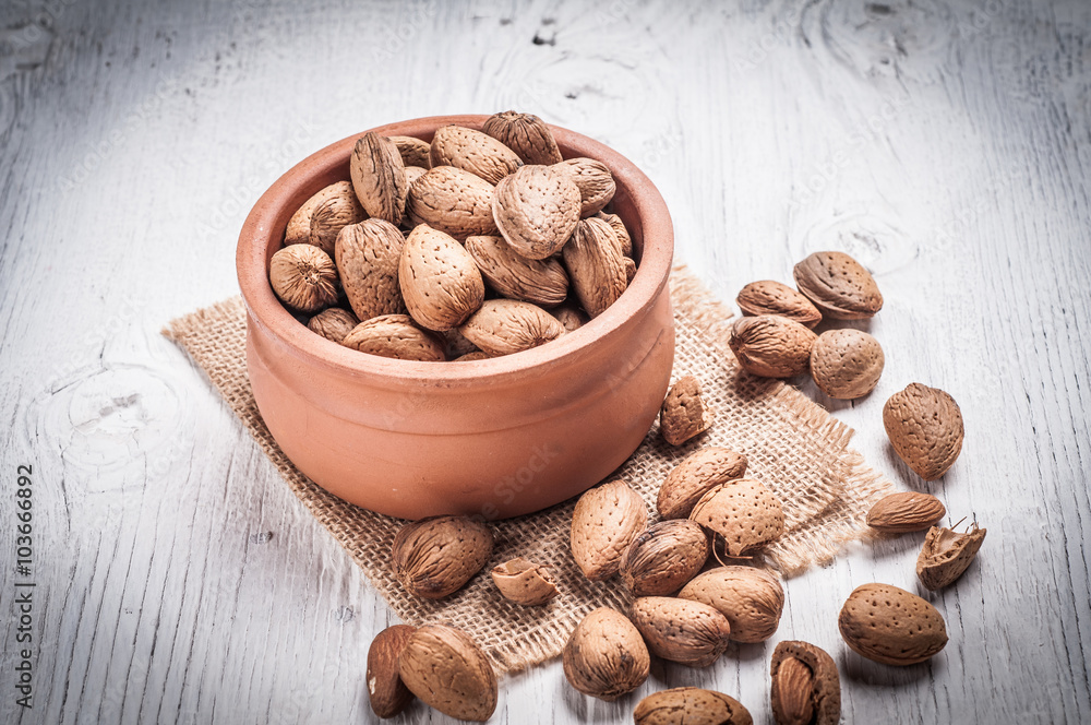 Almond nuts in bowl rustic wooden background Almond nuts in bowl rustic wooden background