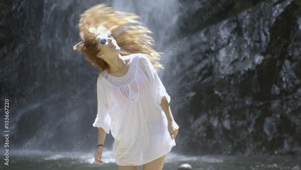 Girl fluttering her long hair near watterfall, slow motion
Girl fluttering her long hair near watterfall, slow motion