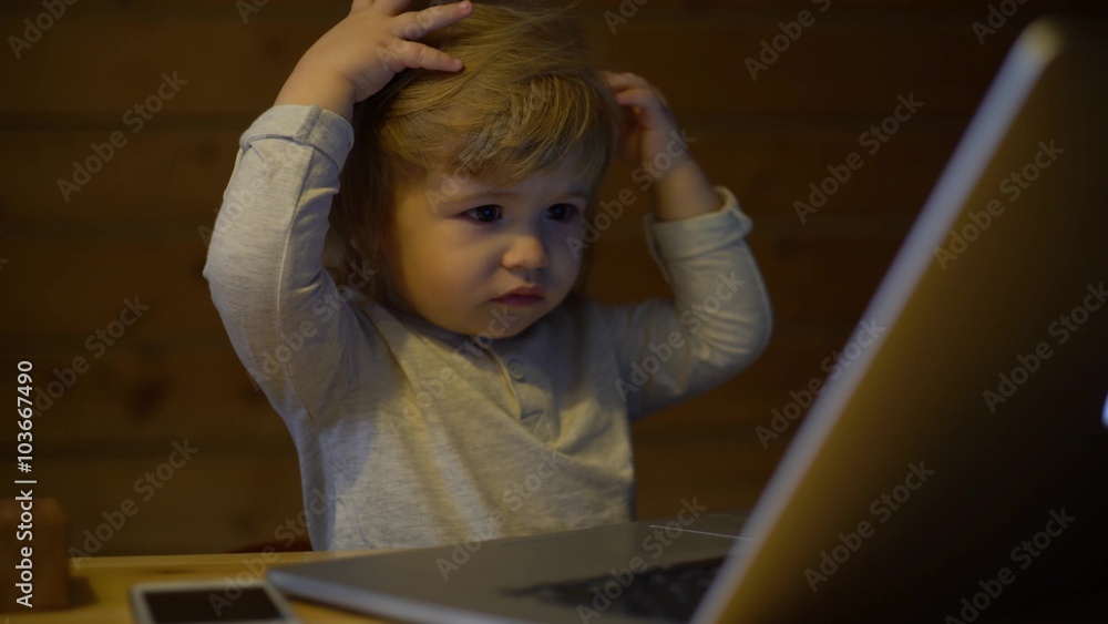 4K Cute serious child works with a laptop 4K Cute serious child works with a laptop