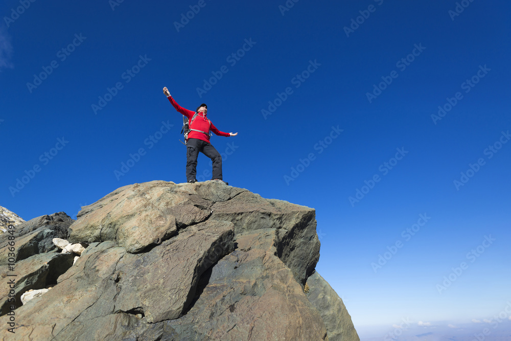 Man on top of mountain