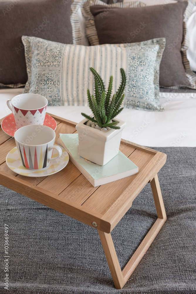 vase of plant and cup of coffee on wooden tray in modern bedroom vase of plant and cup of coffee on wooden tray in modern bedroom