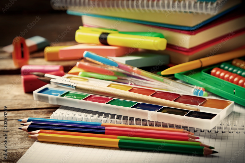 Bright school stationery on old wooden table Bright school stationery on old wooden table