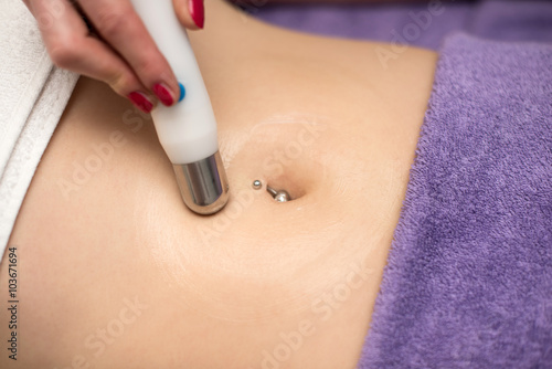 Woman having belly massage in beauty salon. Body care.