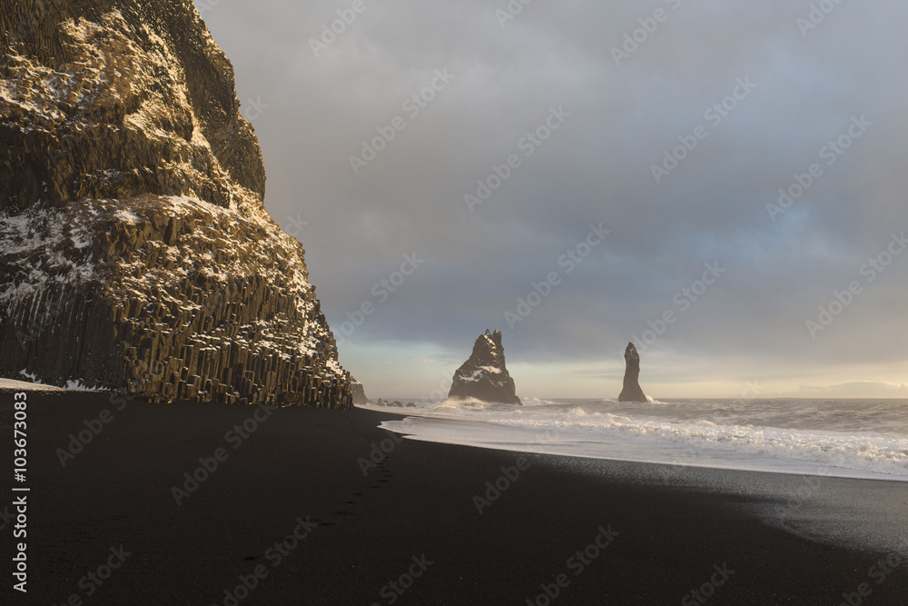 The black sand beach of Reynisfjara and the mount Reynisfjall from the Dyrholaey promontory in the southern coast of Iceland, Vik