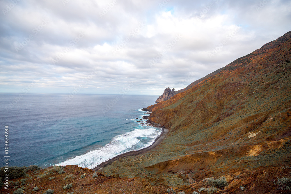 Rocky coastline with stone beach on the western part of La Gomera island near Arguamul village in Spain