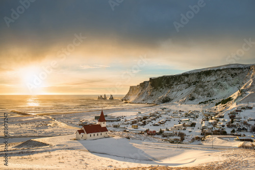 Beautiful view of the small town Vik near Reynisfjara coast and the mountains in winter Iceland in the sunny day