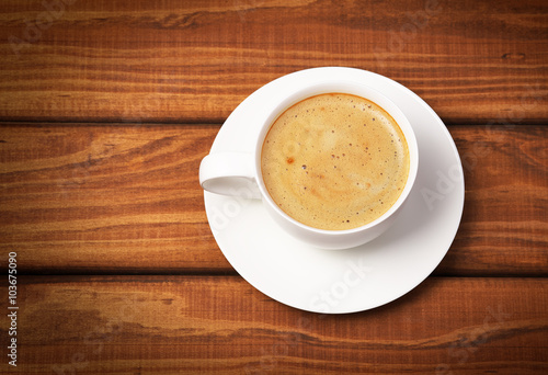 Cup of coffee on wooden background. Concept photo, top view