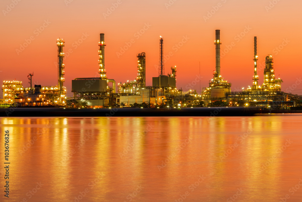 Oil refinery factory in silhouette and sunrise sky