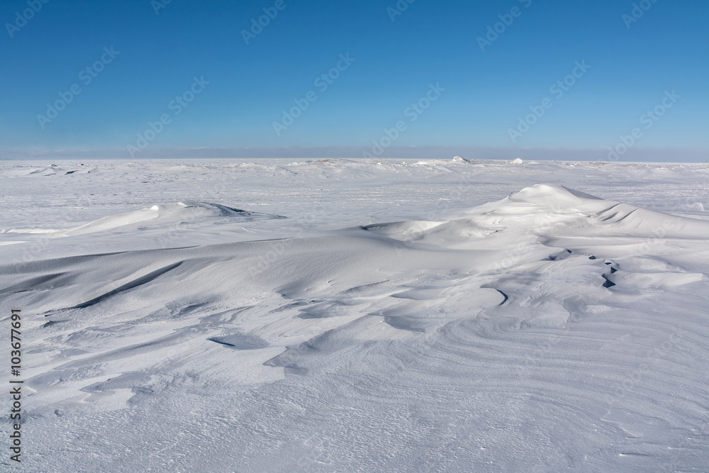 Snow drifts soften the jagged ice at the edge of Lake Superior near Meyers Beach, Wisconsin.