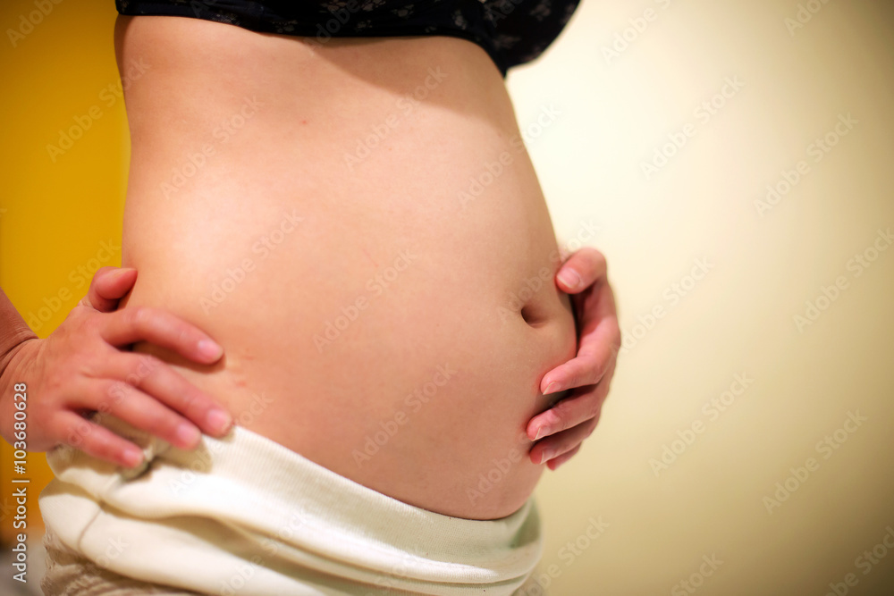 Belly of a pregnant woman on 12 week (3 month) Belly of a pregnant woman on 12 week (3 month)