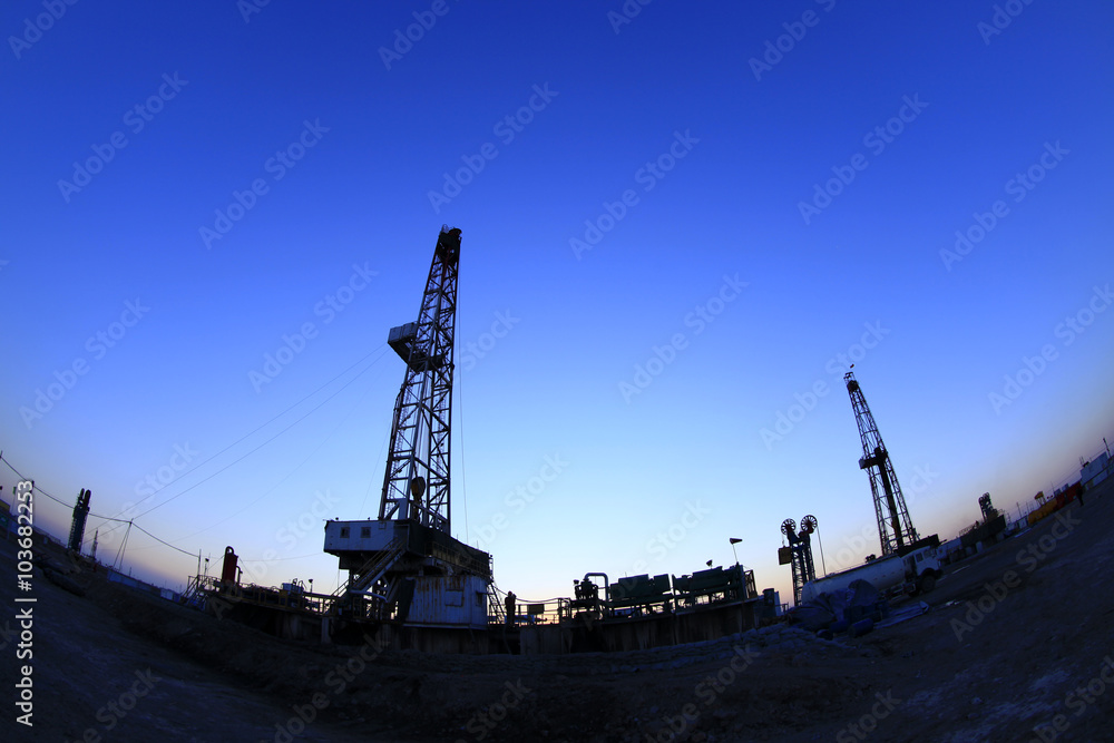 The silhouette of oilfield derrick