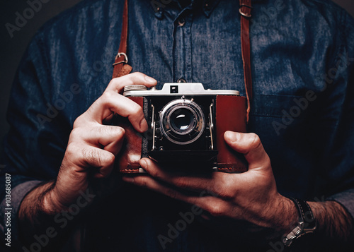 Retro camera in photographers hands