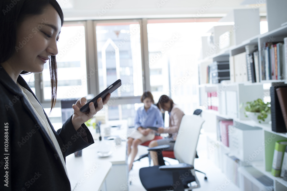 Women are sending e-mail in the office Women are sending e-mail in the office