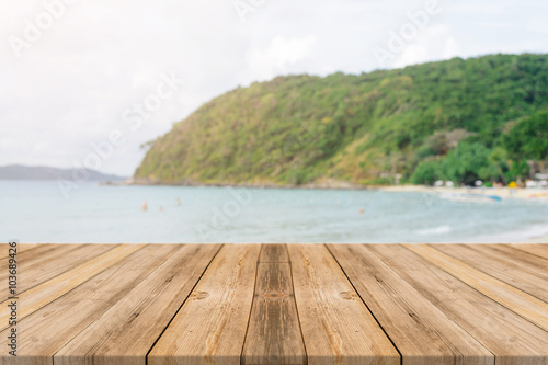 Vintage wooden board empty table in front of blue sea   sky background. Perspective wood floor over sea and sky - can be used for display or montage your products. beach   summer concepts.