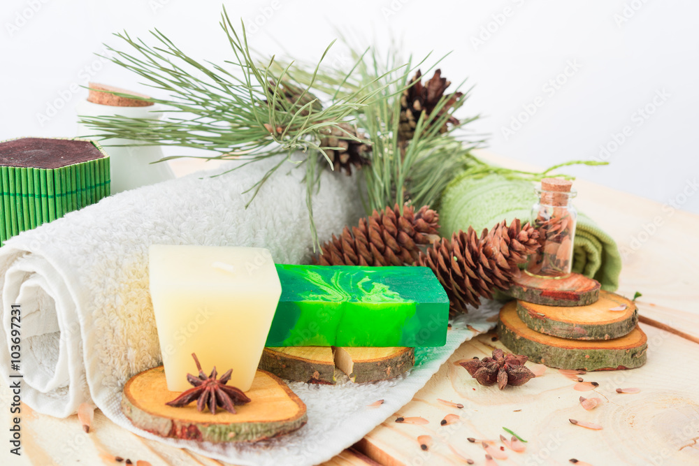 towel, candle and handmade soap on wooden